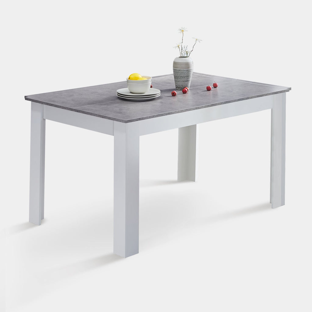 Grey rectangular dining table with a white base, topped with a simple vase, bowl, and plates.