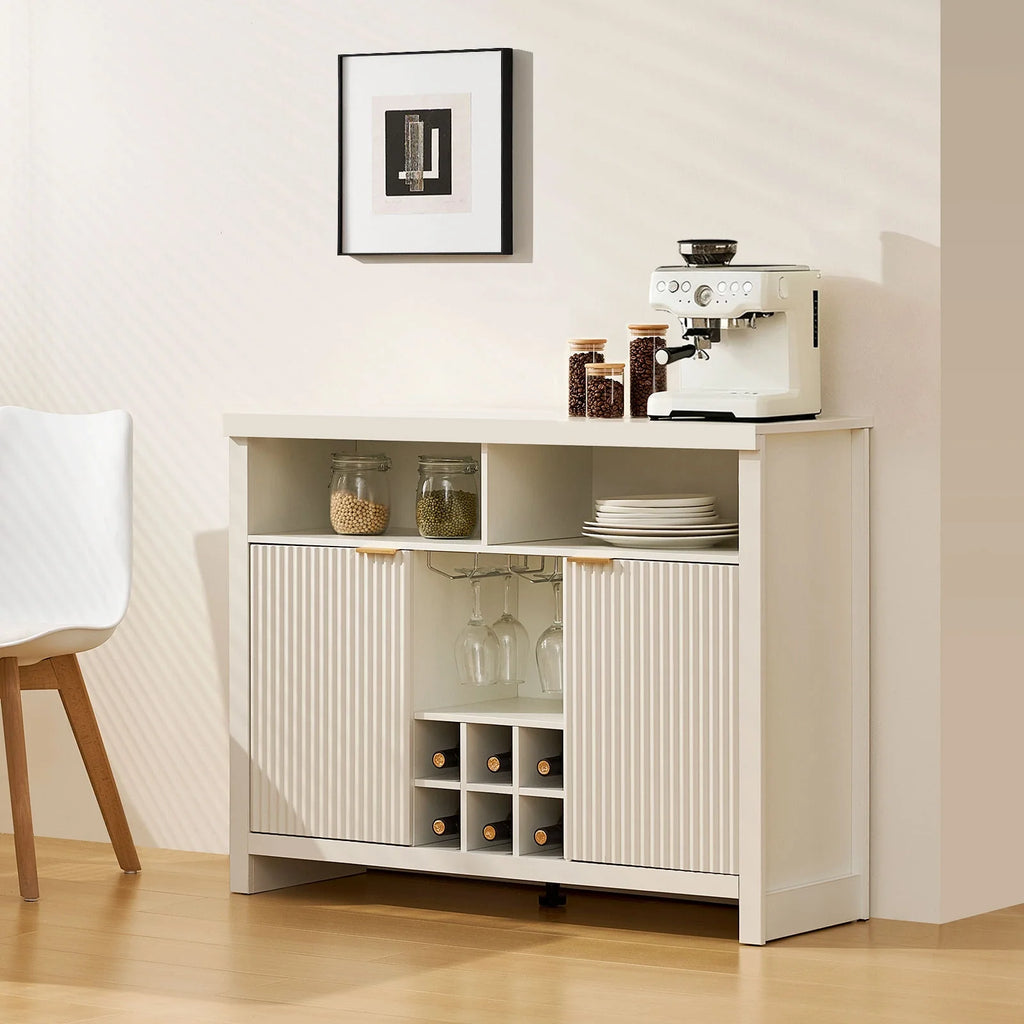 Warm white Arden Wine Bar Cabinet with fluted panel doors, brushed gold handles, open shelves, and a 6-bottle wine rack.