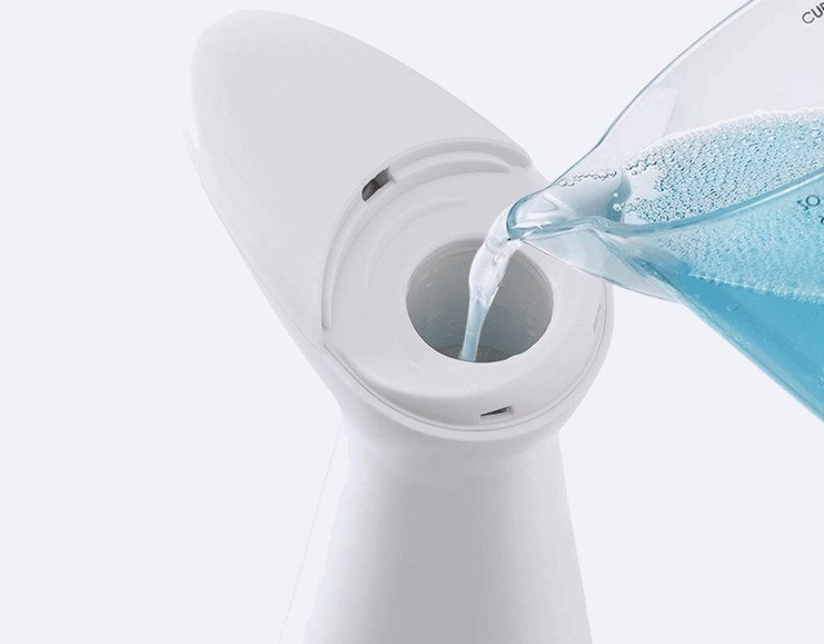 Touchless automatic induction soap dispenser in white, being refilled with blue liquid soap, showcasing a sleek and modern design.