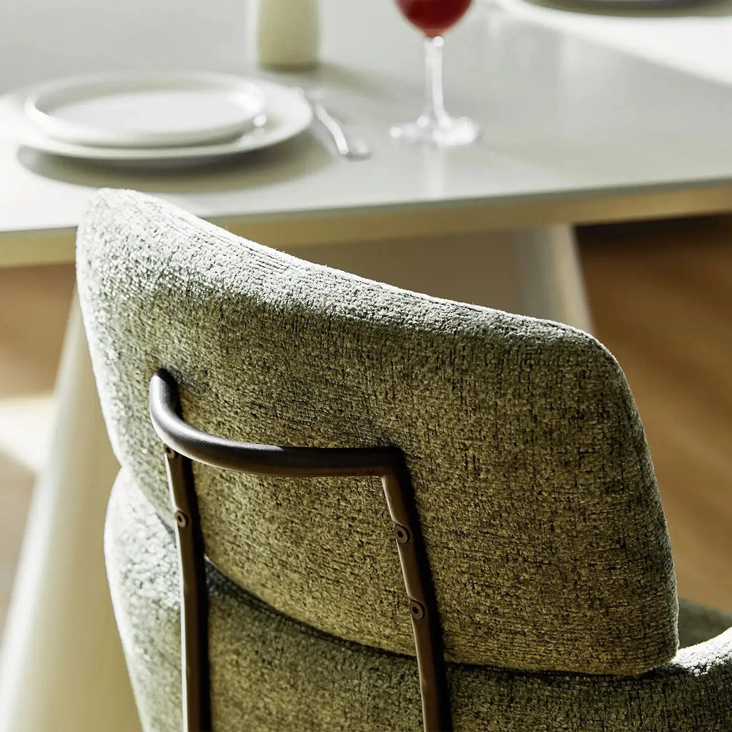 Smoky grey chenille swivel chair featuring a sleek back handle and a contemporary design, perfect for dining or office use.