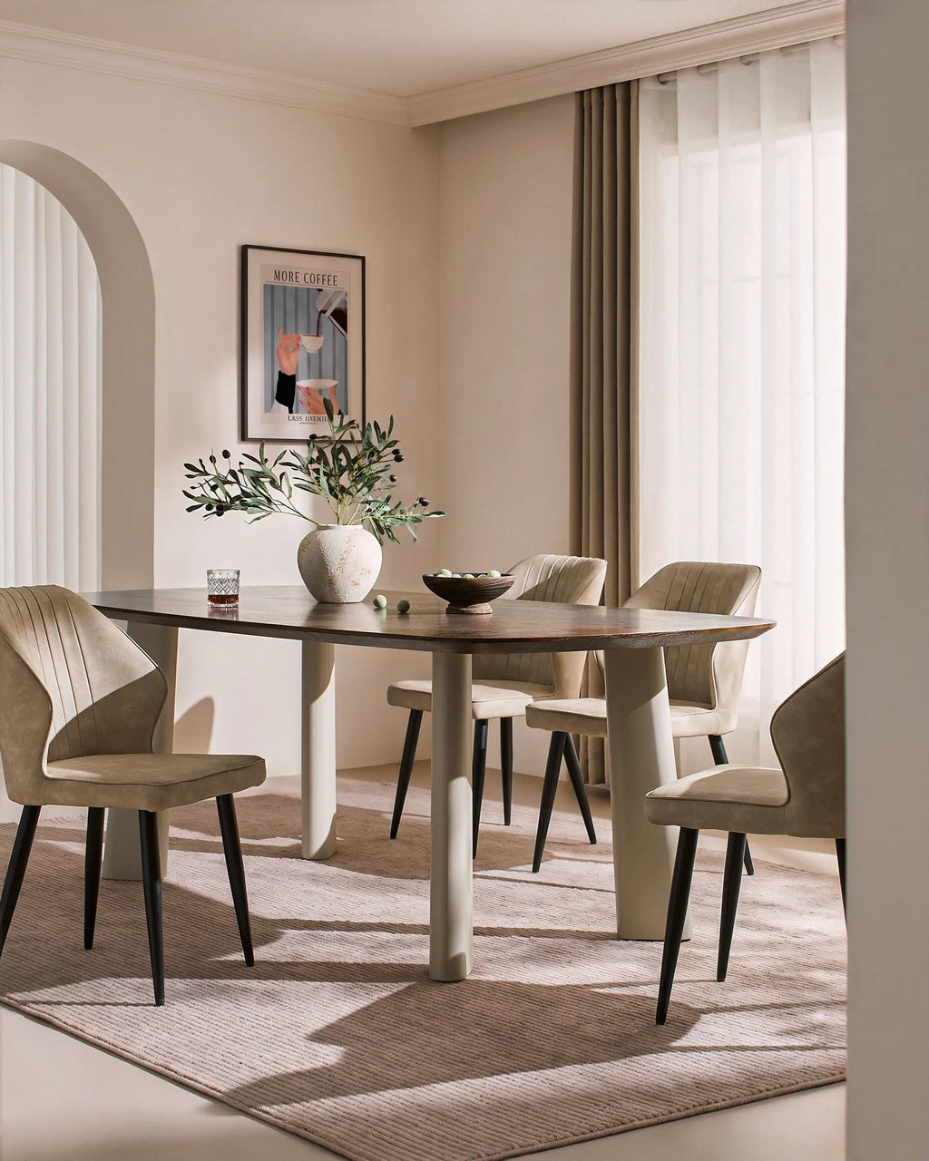 Danforth Faux Leather Dining Chairs in beige with black metal legs, set around a dining table in a softly lit room.