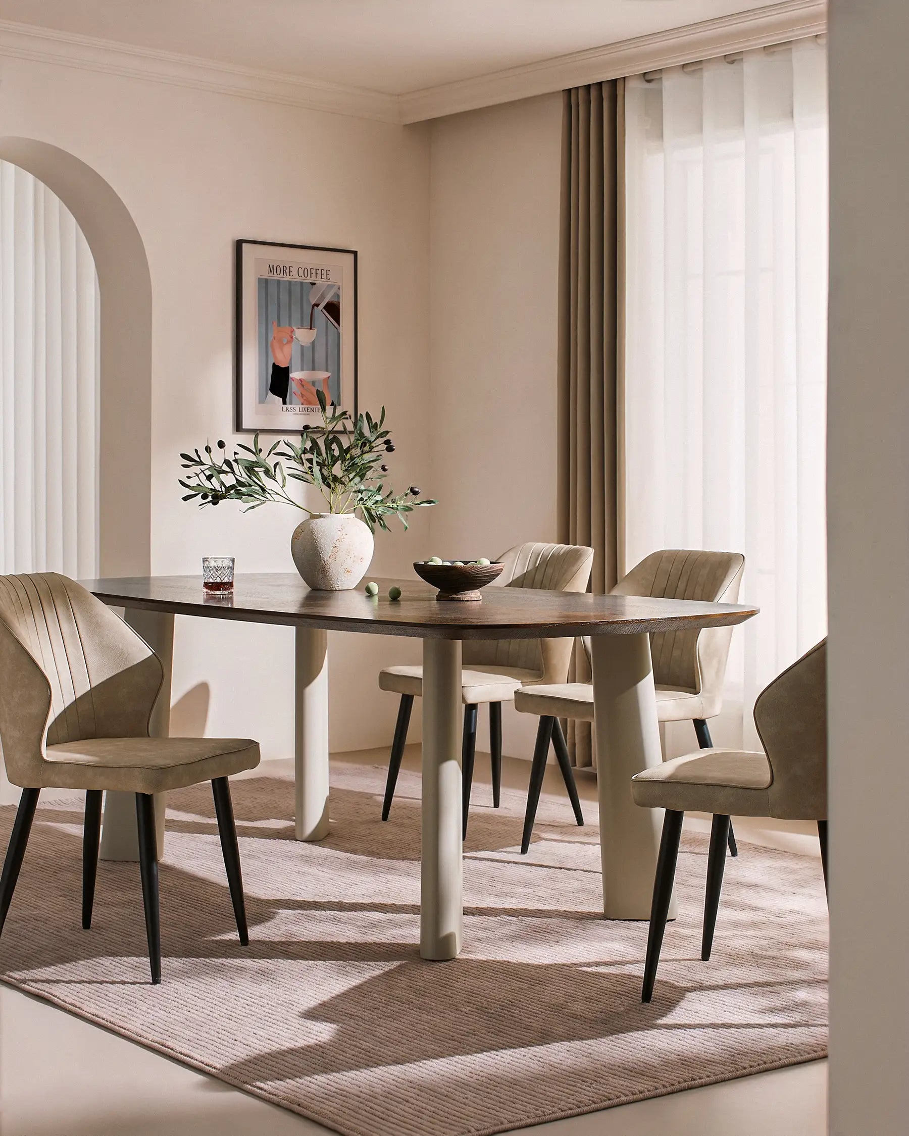 Danforth Faux Leather Dining Chairs in beige with black metal legs, set around a dining table in a softly lit room.