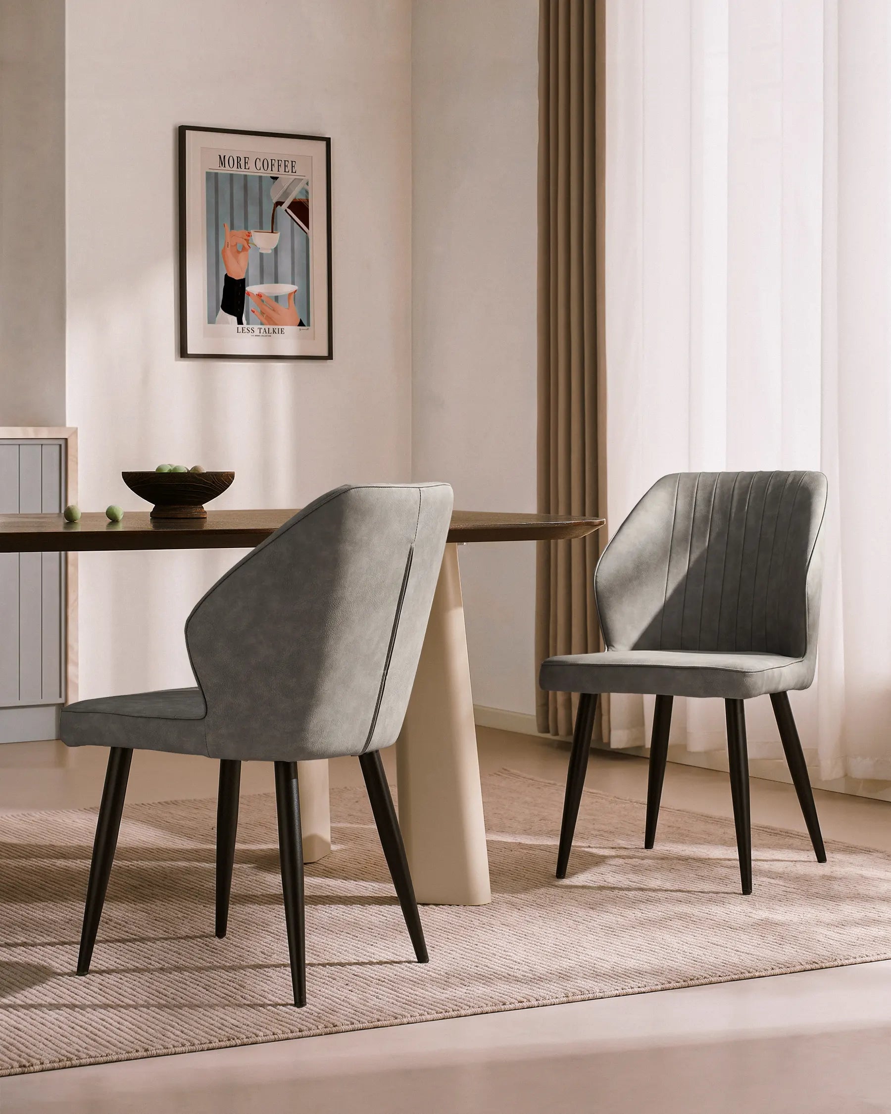 Beige and light grey faux leather dining chairs with black legs, showcasing a modern and comfortable design.