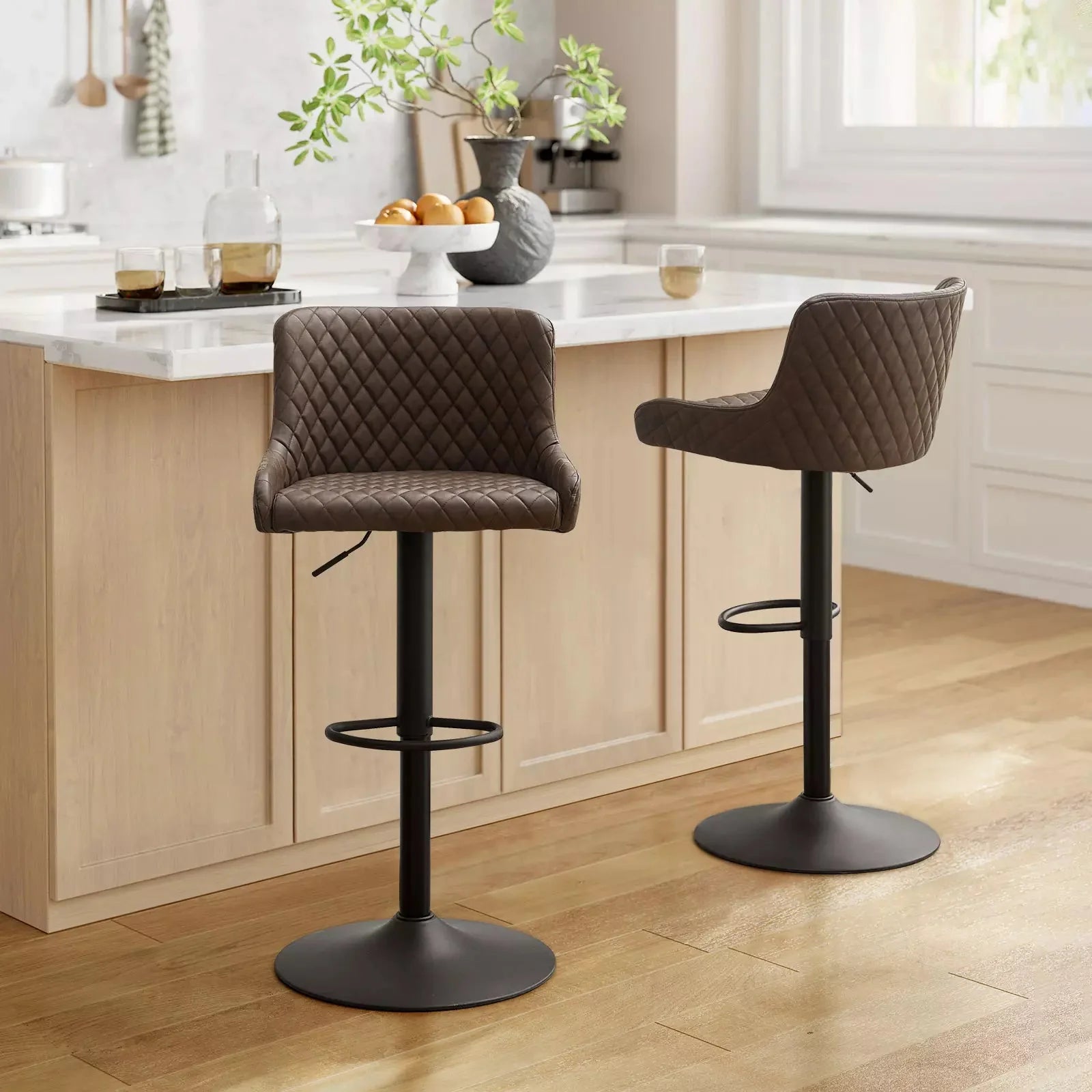 Height adjustable, brown faux leather bar stools with quilted design and sturdy black metal bases, set of two.