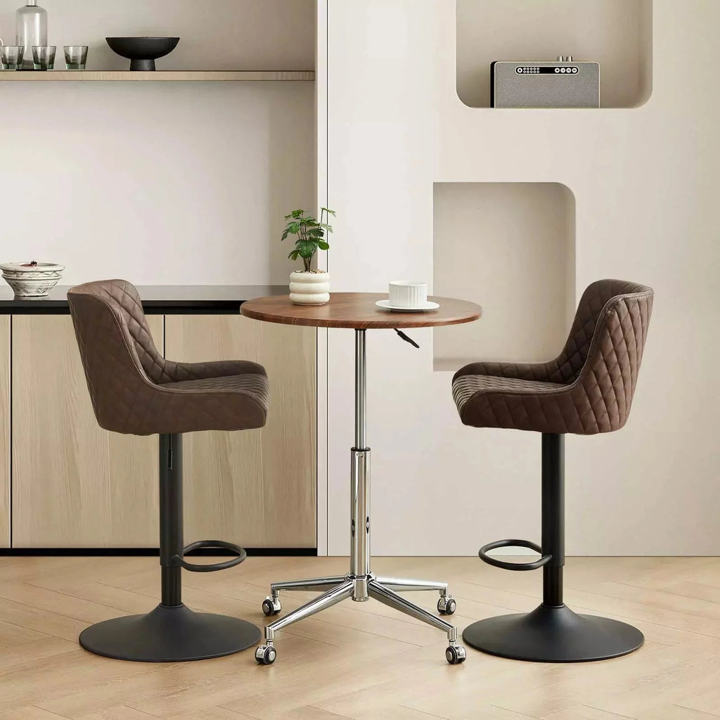 Set of 2 Dundas faux leather bar stools in brown with quilted stitching, height adjustable, resting by a round wooden table.