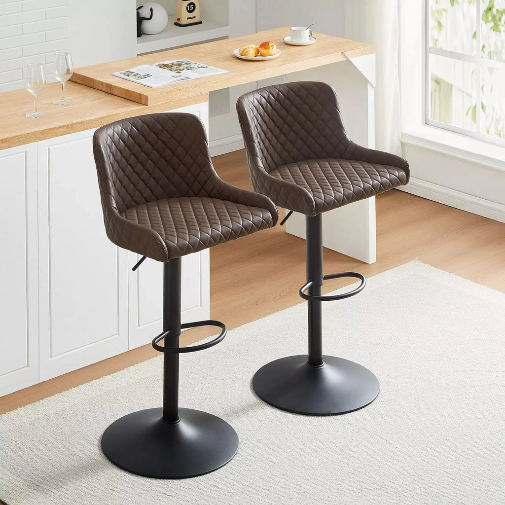Height-adjustable Dundas faux leather bar stools in brown, featuring a quilted design, metal base, and footrest.