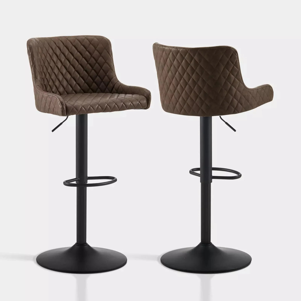 Height-adjustable Dundas bar stools in brown faux leather with quilted pattern and black metal base, sold as a set of two.