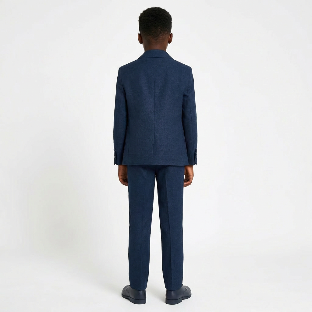 Navy blue boys' formal suit featuring a structured blazer and tailored trousers, shown from the back.