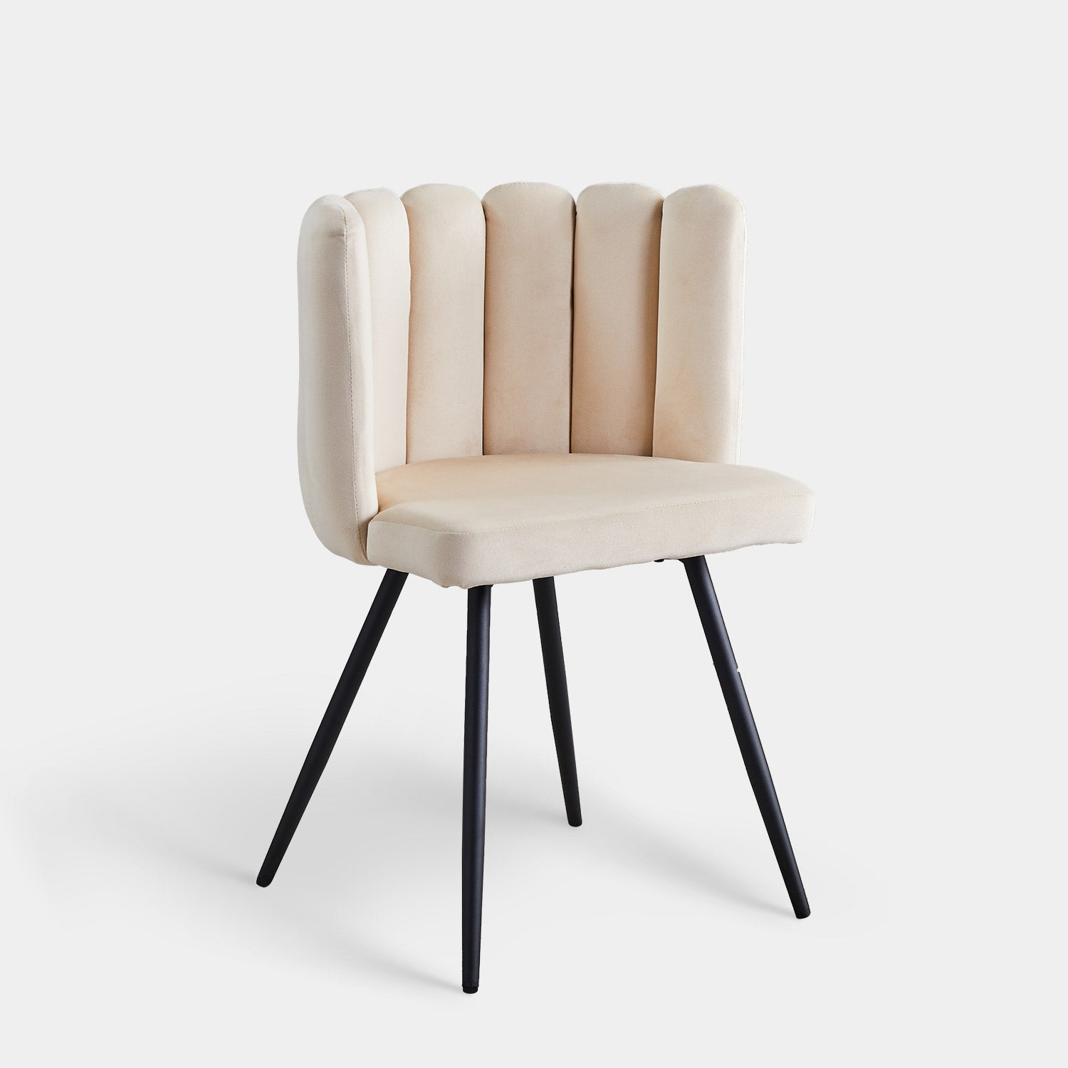 Beige tufted velvet accent dining chair with a petal-shaped backrest and black tapered metal legs.