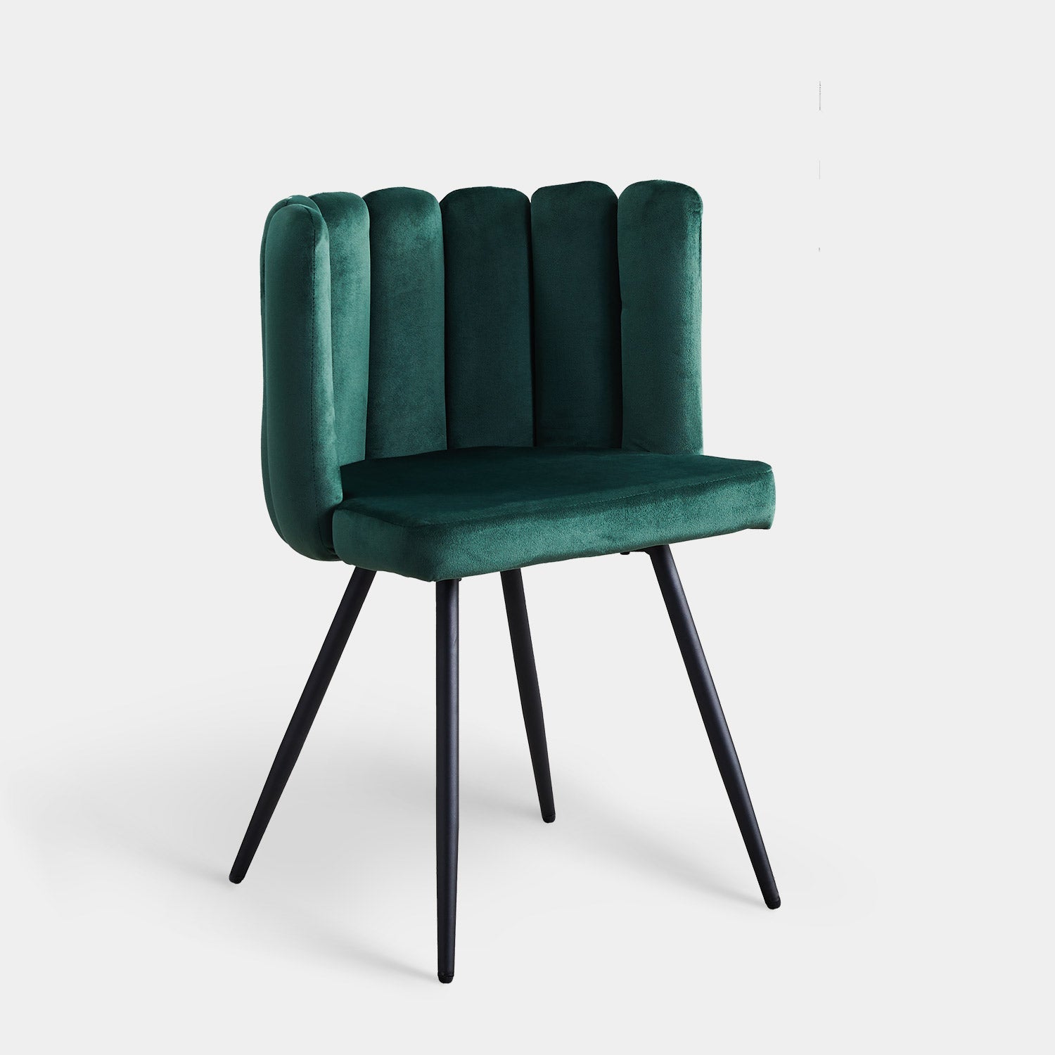Tufted velvet accent dining chair in deep green with a petal backrest and tapered black metal legs.