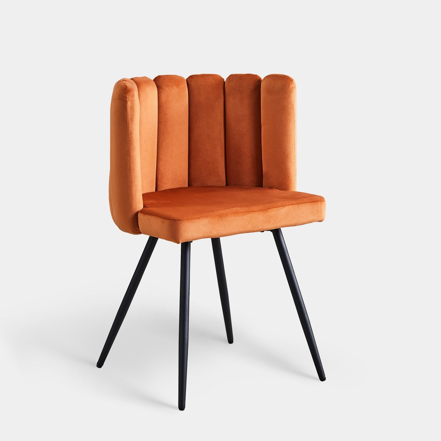 Velvet dining chair in a vibrant orange color, featuring a petal curved backrest and sleek black tapered legs.