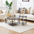 Black tempered glass nesting coffee tables with metal legs, round shape, set of two, placed in a cozy living room setting.
