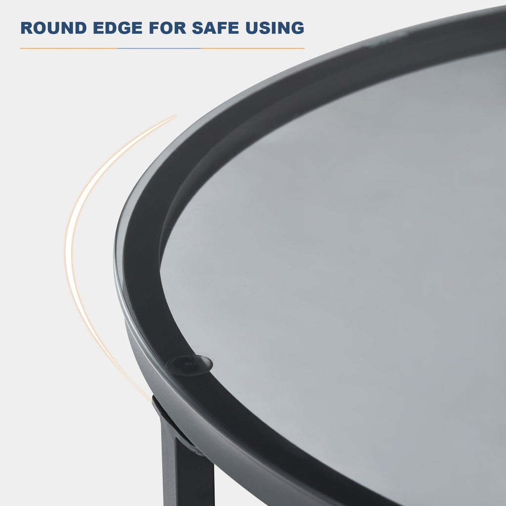 Tempered glass coffee table with a round top, black color, and beveled edges; metal legs provide sturdy support.