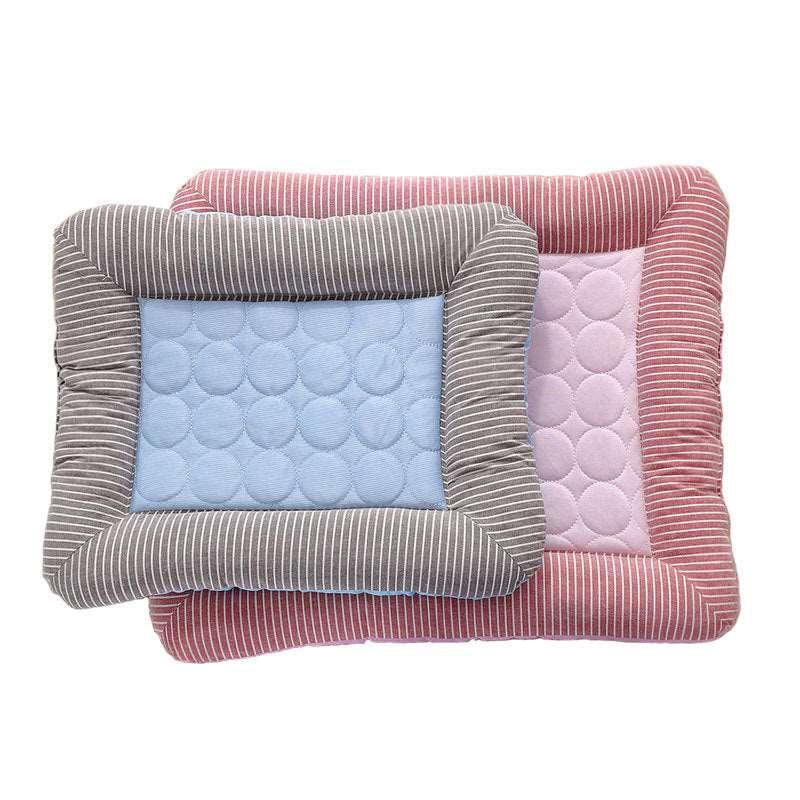 Light blue and gray striped pet cooling pad with a cushioned dot pattern, layered on a pink striped pad.
